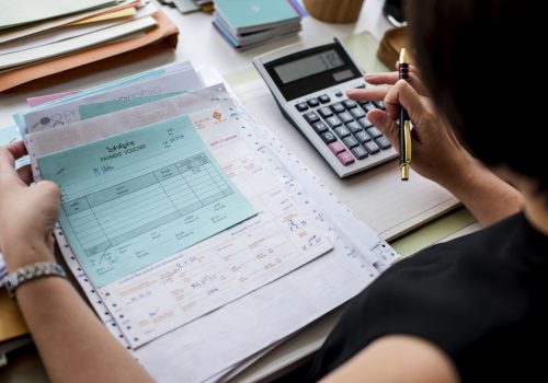 Asian woman working through paperwork Asian woman working through paperwork