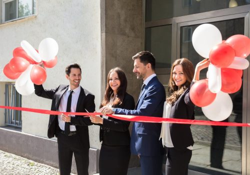 businesspeople-cutting-red-ribbon-1-scaled.jpg